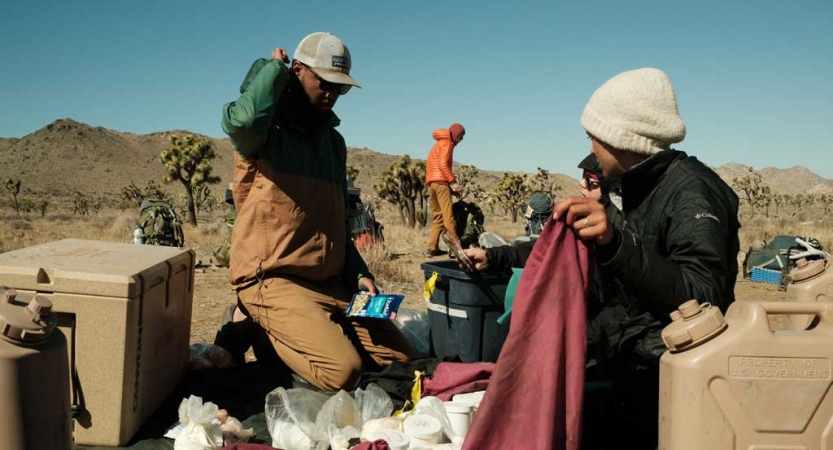 two people do camp tasks in Joshua Tree National Park